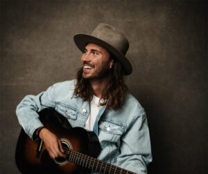 Seph Schlueter playing on the guitar