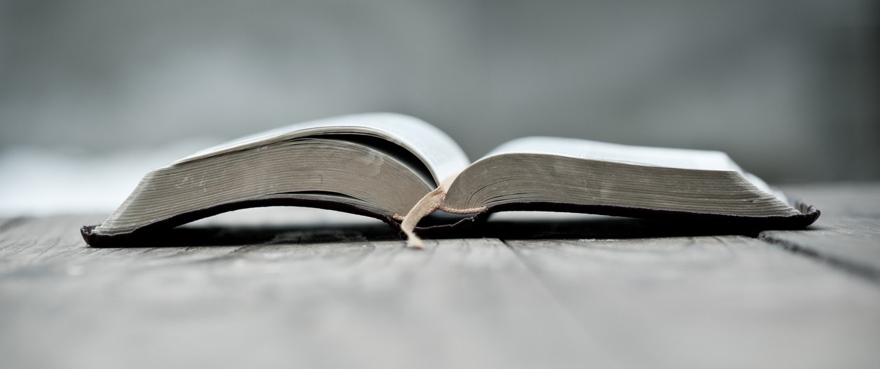 The Bible laying open on a wooden table